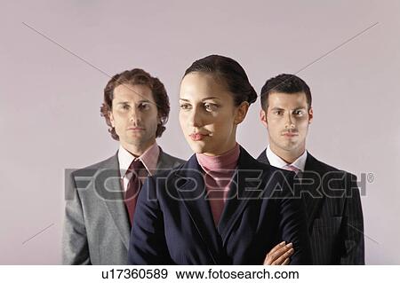 Businesswoman standing in front of businessmen, portrait View Large Photo Image Stock Photo - Businesswoman standing in front of businessmen, portrait. Fotosearch