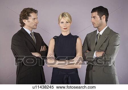 Stock Photography - Businesswoman surrounded by businessmen, portrait. Fotosearch