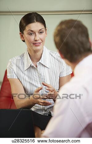 Stock Photograph - Businesswoman Talking in Meeting, close-up. Fotosearch