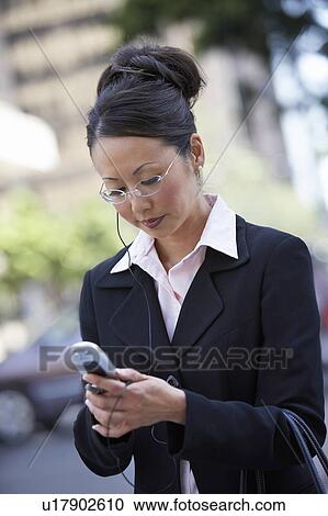 Businesswoman Using Cell Phone, outdoors View Large Photo Image Stock Image - Businesswoman Using Cell Phone, outdoors. Fotosearch