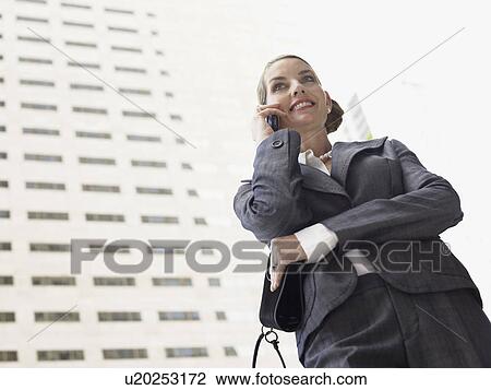 Businesswoman using mobile phone, outdoors View Large Photo Image Stock Image - Businesswoman using mobile phone, outdoors. Fotosearch