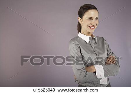 Stock Photo - Businesswoman with arms crossed, portrait. Fotosearch
