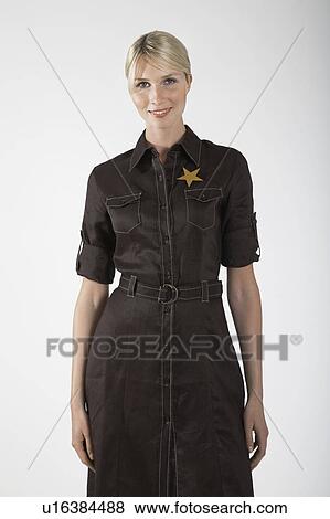 Stock Photo - Businesswoman with gold star on dress, portrait. Fotosearch