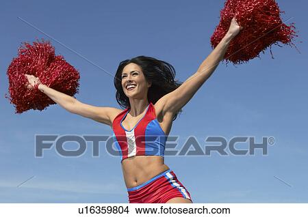Cheerleader running with pom poms raised View Large Photo Image Picture - Cheerleader running with pom poms raised. Fotosearch