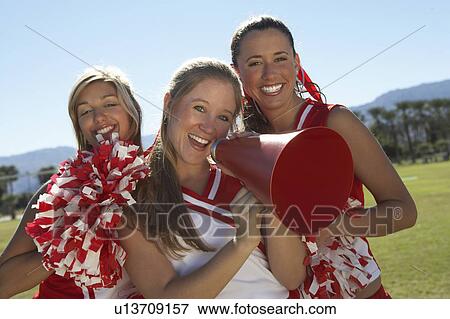 Cheerleaders Holding Megaphone on field, portrait, (portrait) View Large Photo Image Stock Photo - Cheerleaders Holding Megaphone on field, portrait, (portrait). Fotosearch