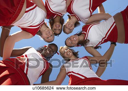 Cheerleaders in Huddle, view from below, (view from below) View Large Photo Image Picture - Cheerleaders in Huddle, view from below, (view from below). Fotosearch