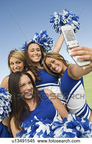 Cheerleaders photographing self with camera phone View Large Photo Image Stock Photography - Cheerleaders photographing self with camera phone. Fotosearch