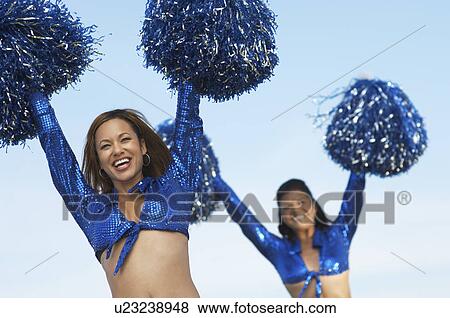 Cheerleaders with pom poms raised View Large Photo Image Stock Photo - Cheerleaders with pom poms raised. Fotosearch