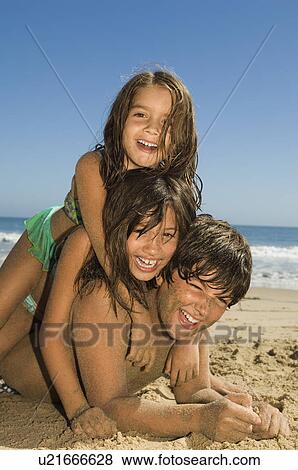Children in swimwear playing on beach View Large Photo Image Stock Photo - Children in swimwear playing on beach. Fotosearch