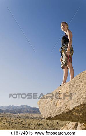 Climber standing on Rock Looking at Desert View Large Photo Image Stock Photography - Climber standing on Rock Looking at Desert. Fotosearch