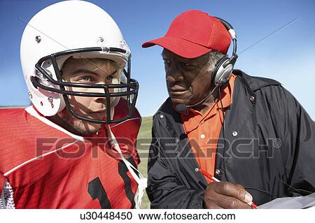 Coach talking to football player, close-up View Large Photo Image Stock Image - Coach talking to football player, close-up. Fotosearch