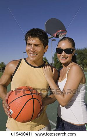 Stock Image - Couple at Basketball Court.. Fotosearch