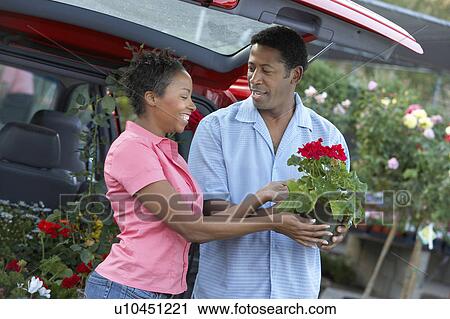 Couple choosing plants at nursery View Large Photo Image Stock Image - Couple choosing plants at nursery. Fotosearch