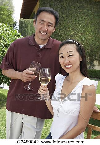 Couple drinking wine in garden View Large Photo Image Stock Image - Couple drinking wine in garden. Fotosearch