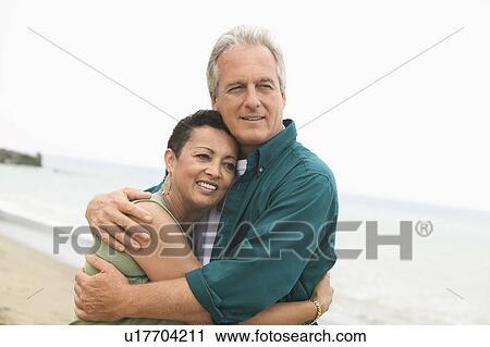 Couple embracing on beach View Large Photo Image Stock Image - Couple embracing on beach. Fotosearch