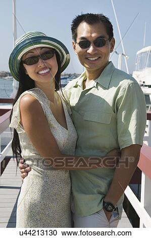 Couple embracing on pier, (portrait) View Large Photo Image Stock Image - Couple embracing on pier, (portrait). Fotosearch