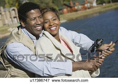 Couple fly fishing together, smiling View Large Photo Image Stock Photo - Couple fly fishing together, smiling. Fotosearch