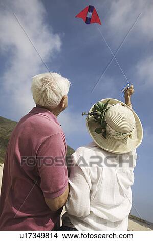 Picture - Couple flying kite outdoors. Fotosearch