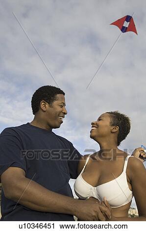 Couple flying kite, outdoors View Large Photo Image Stock Image - Couple flying kite, outdoors. Fotosearch