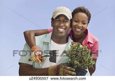 Stock Photo - Couple gardening, (portrait). Fotosearch