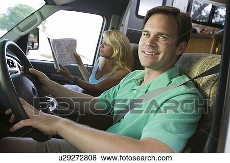 Couple in camper van View Large Photo Image Stock Photo - Couple in camper van. Fotosearch