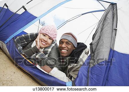 Couple in warm clothing, lying down in tent View Large Photo Image Stock Photo - Couple in warm clothing, lying down in tent. Fotosearch