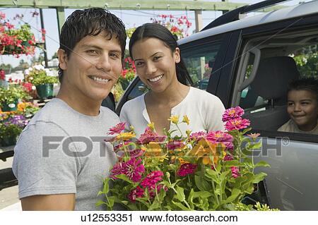 Couple Loading Plants into Minivan at plant nursery, portrait View Large Photo Image Stock Image - Couple Loading Plants into Minivan at plant nursery, portrait. Fotosearch