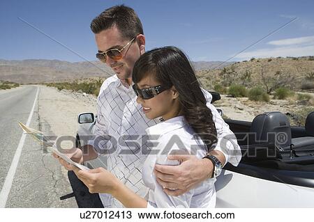 Couple look at map View Large Photo Image Stock Image - Couple look at map. Fotosearch