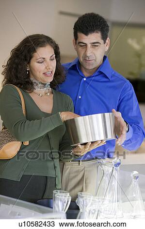 Stock Image - Couple Looking at Kitchenware in store. Fotosearch