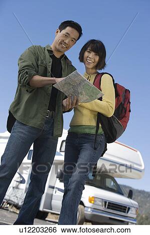 Couple looking at map outside RV, low angle view View Large Photo Image Stock Photograph - Couple looking at map outside RV, low angle view. Fotosearch