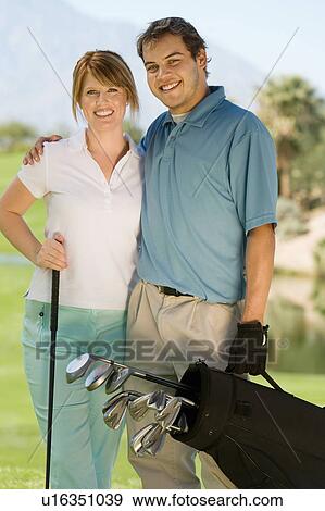 Couple of golfers embracing on golf course, (portrait) View Large Photo Image Stock Photo - Couple of golfers embracing on golf course, (portrait). Fotosearch
