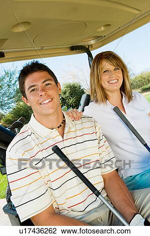 Couple of golfers riding in golf cart, (portrait) View Large Photo Image Stock Image - Couple of golfers riding in golf cart, (portrait). Fotosearch