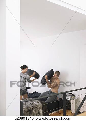 Couple on Bed Having a Pillow Fight View Large Photo Image Stock Image - Couple on Bed Having a Pillow Fight. Fotosearch
