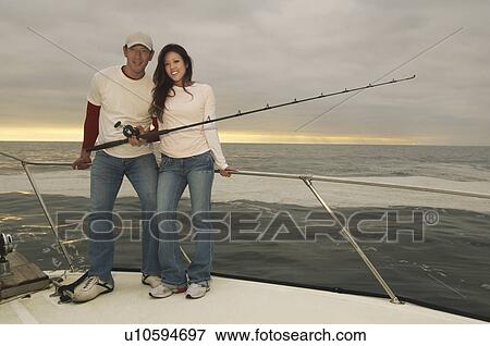 Stock Photo - Couple on fishing boat, (portrait). Fotosearch