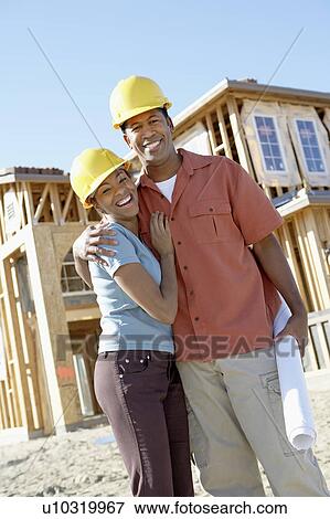 Stock Photo - Couple on new home building site. Fotosearch