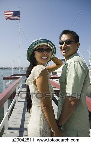 Couple on pier, (portrait) View Large Photo Image Stock Image - Couple on pier, (portrait). Fotosearch