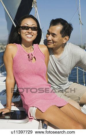Stock Photo - Couple on sailboat. Fotosearch