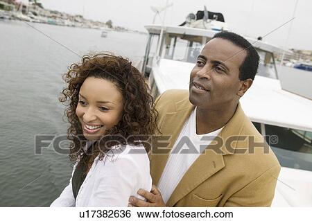 Stock Photograph - Couple on yacht, (elevated view). Fotosearch