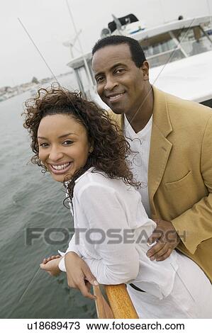 Stock Image - Couple on yacht, (portrait). Fotosearch