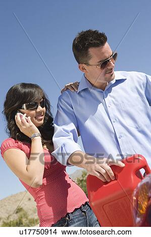 Picture - Couple refuelling car. Fotosearch