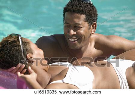Couple Relaxing in Swimming Pool View Large Photo Image Stock Photography - Couple Relaxing in Swimming Pool. Fotosearch