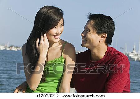Stock Image - Couple relaxing on boat. Fotosearch