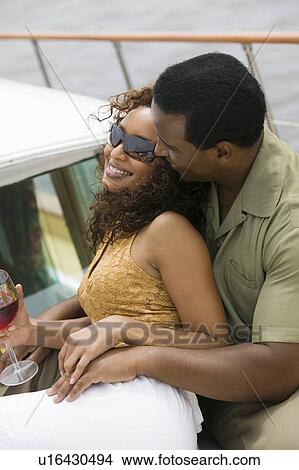 Picture - Couple relaxing on yacht. Fotosearch