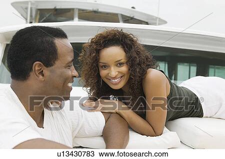 Couple relaxing on yacht, (portrait) View Large Photo Image Stock Image - Couple relaxing on yacht, (portrait). Fotosearch