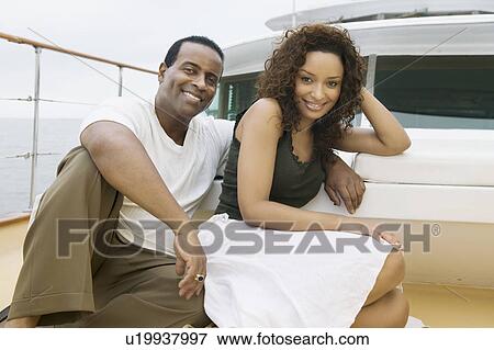 Couple relaxing on yacht, (portrait) View Large Photo Image Stock Photo - Couple relaxing on yacht, (portrait). Fotosearch