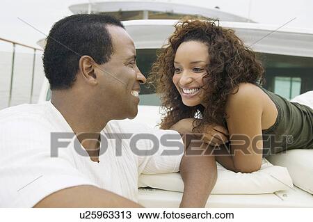Stock Image - Couple relaxing on yacht. Fotosearch