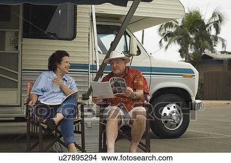 Couple relaxing outside motor home View Large Photo Image Picture - Couple relaxing outside motor home. Fotosearch