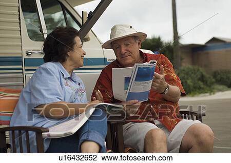 Couple relaxing outside motor home View Large Photo Image Stock Image - Couple relaxing outside motor home. Fotosearch