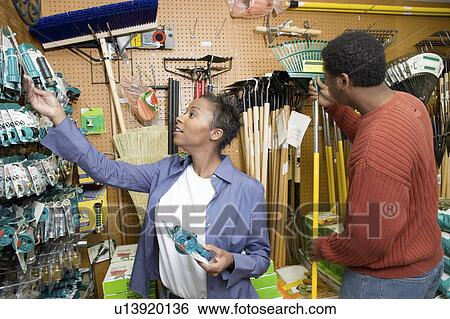 Couple selecting garden tools in shop View Large Photo Image Stock Photograph - Couple selecting garden tools in shop. Fotosearch