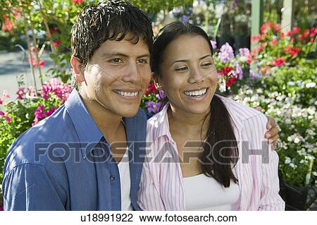Couple Sitting Among flowers at plant nursery, portrait View Large Photo Image Stock Image - Couple Sitting Among flowers at plant nursery, portrait. Fotosearch